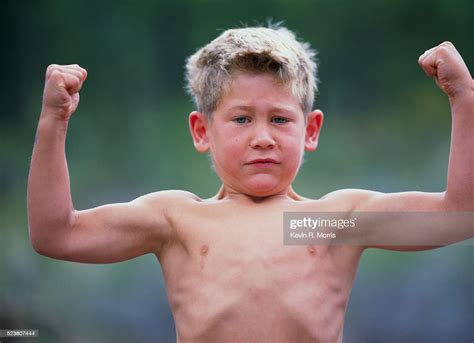 Boy Flexing His Muscles High Res Stock Photo Getty Images