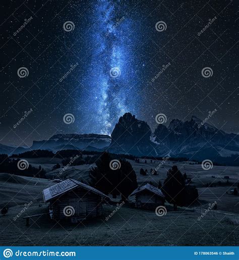 Milky Way Over Wooden Huts In Alpe Di Siusi Dolomites Stock Photo