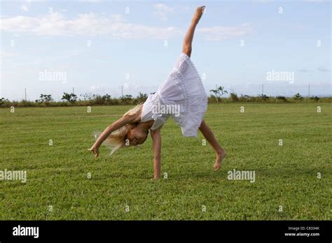 Girl Doing A Cartwheel Stock Photo Alamy