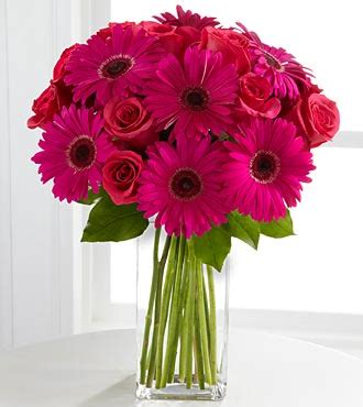 These two flowers make an enchanting wedding bouquet arrangement. Bouquet Bridal: Pink Gerbera and Rose Wedding Bouquet