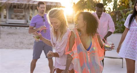 Happy Diverse Friends Having Party By Swimming Pool Holding Cocktails And Dancing Stock Image