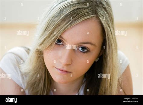 head and shoulder shot of teenage 16 18 years old woman facing with eye contact long blonde