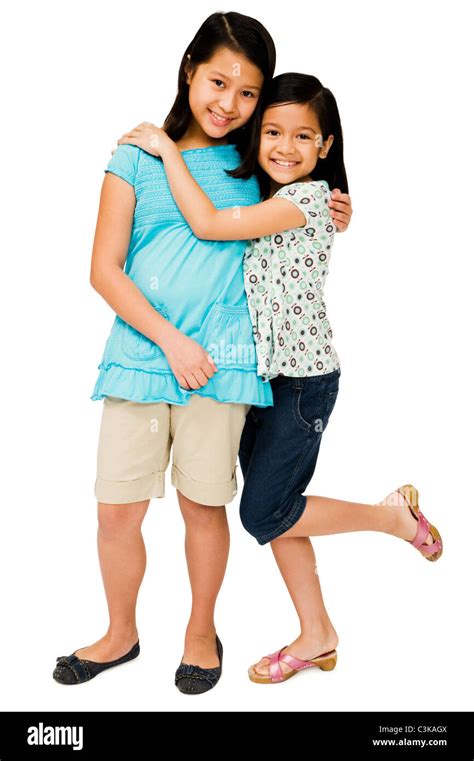 Close Up Of Two Girls Hugging Each Other And Smiling Isolated Over