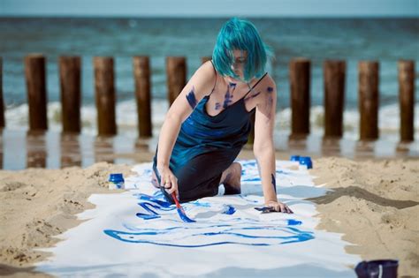 Premium Photo Artistic Blue Haired Woman Performance Artist In Dark Blue Dress Smeared With