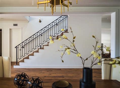 The staircase features black spindles and railings to match the black windows. Modern farmhouse style home in California with glamorous elements | Modern farmhouse style ...