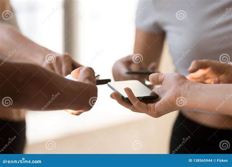 Close Up Of People Use Smartphones Exchanging Contacts Stock Photo