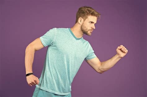 Premium Photo Man In Tshirt And Shorts On Violet Background Runner In