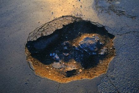 The repair material stands out like a sore thumb. How to Fix a Pothole in Your Driveway (With images) | Driveway, Asphalt driveway, Blacktop driveway