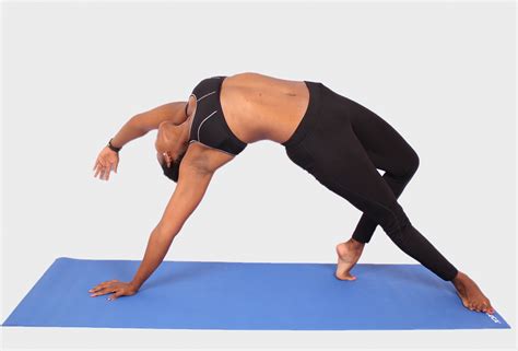 Woman Doing Yoga Pose On Blue Yoga Mat