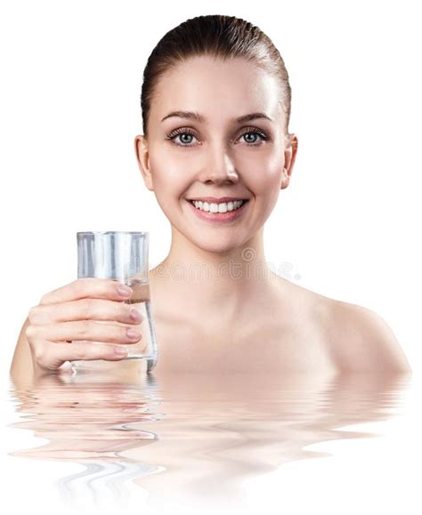 Woman Holds Glass In Water With Crystal Clear Surface Stock Photo