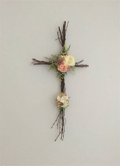 A Cross Made Out Of Branches And Flowers