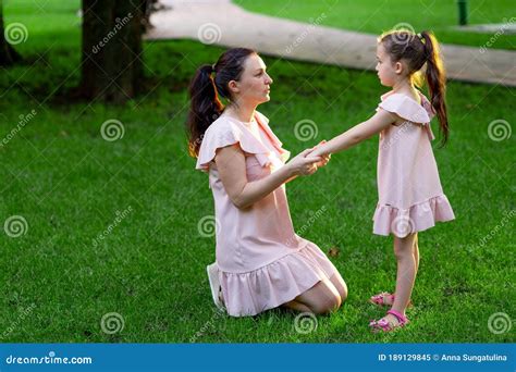 Mother And Daughter 5 6 Years Old Walking In The Park In The Summer Daughter And Mother