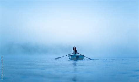 Mystical Woman In Row Boat On A Foggy New England Morning By Howl Stocksy United