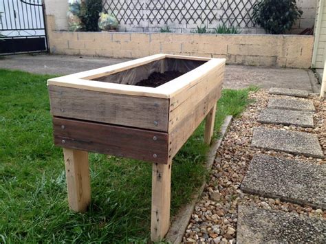 The bottom of the planter is covered with board to hold the soil and enable easy movement. Planter Boxes from Pallets