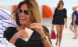 kelly bensimon shows off her amazing bikini body while enjoying a pina colada on the beach