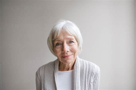 Studio Portrait Of Senior Woman On Simple Grey Background Del Colaborador De Stocksy Rob And