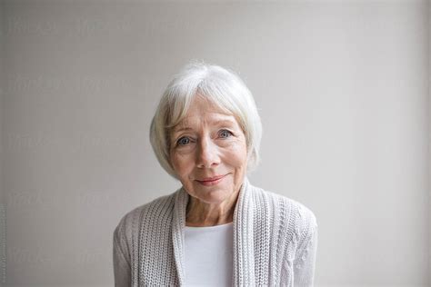 Studio Portrait Of Senior Woman On Simple Grey Background Del