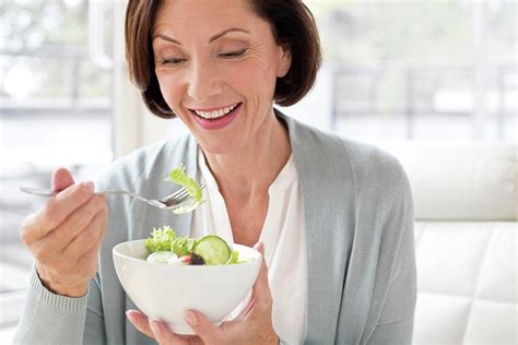 Mature Woman Eating Salad Photograph By Science Photo Library