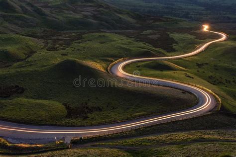 Winding Curvy Rural Road With Light Trail From Headlights Leading