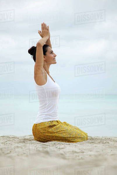 Mature Woman Kneeling In Prayer Position With Hands Above Head Side View Stock Photo Dissolve