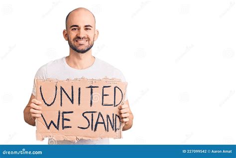 Young Handsome Man Holding United We Stand Banner Looking Positive And