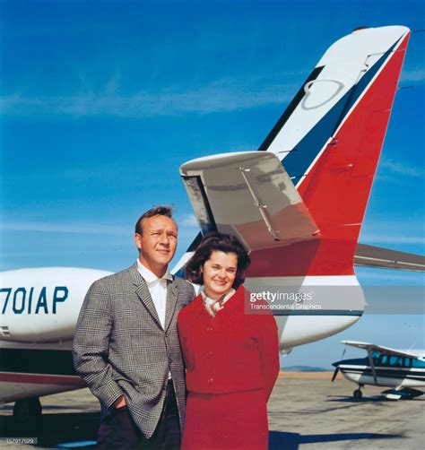 Arnold Palmer And His Wife Pose In Front Of Their Personal Airplane
