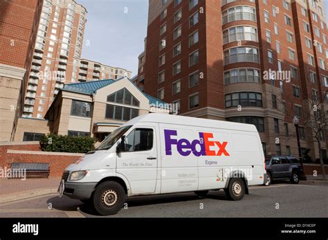 FedEx delivery van parked in front of apartment building - Arlington