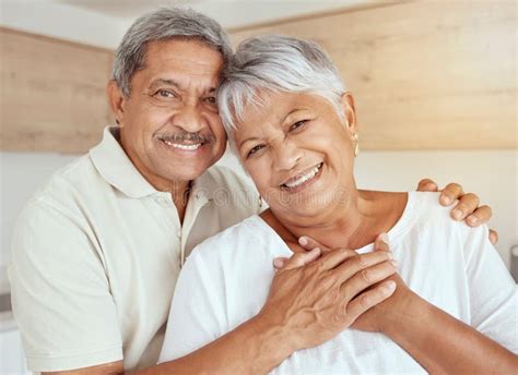 Portrait Of Mixed Race Senior Couple Hugging In The Morning At Home Smiling Elderly Husband And