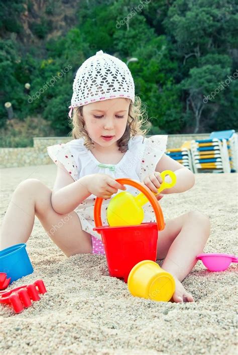 Little Girl Playing With Toys On The Beach Stock Photo By ©mproduction