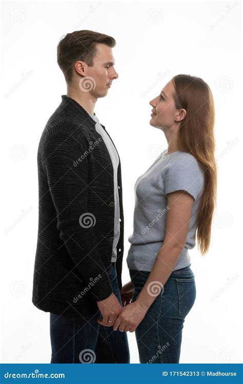 the guy and the girl are standing in front of each other and have taken their hands stock image