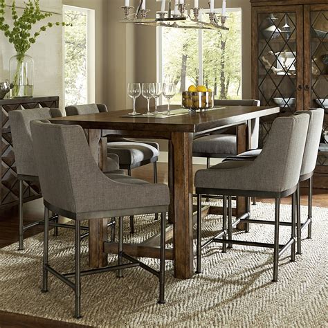 A group seated at a table for a meal. Loon Peak Segula Counter Height Dining Table | Wayfair