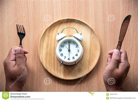 The Clock Is At 1200 Noon For Lunch In A Wooden Dish Stock Image