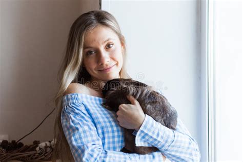 Pet And Easter Concept Happy Girl Hugging Brown Rabbit At Home Stock