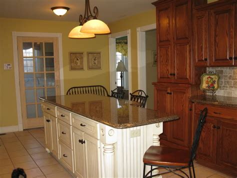 Learn how to paint oak cabinets with this detailed tutorial that includes tips and tricks for filling in the oak grain for a super smooth finish!. Craft island idea. Perimeter Cabinets are Oak with ...