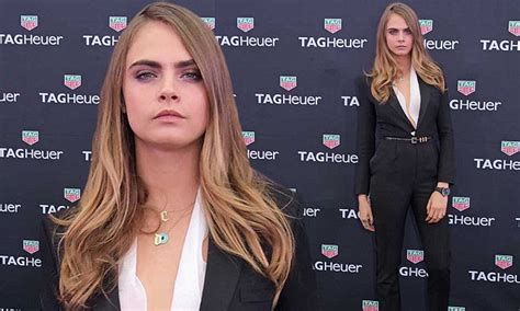Suited And Booted Cara Delevingne Flashes Her Cleavage In A Plunging Jumpsuit And A Chic White