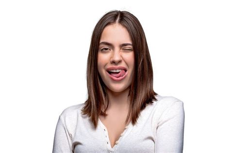 Premium Photo Portrait Of Funny Girl With Showing Tongue Winking With One Eye Making Faces