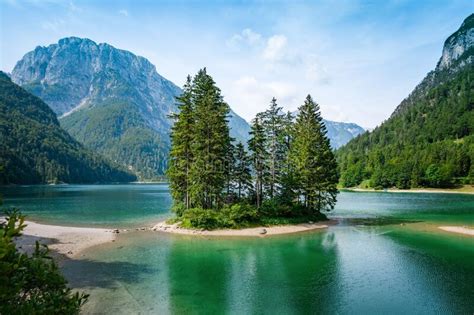 Breathtaking View Of Lush Trees And Emerald Green Waters In Lago Del