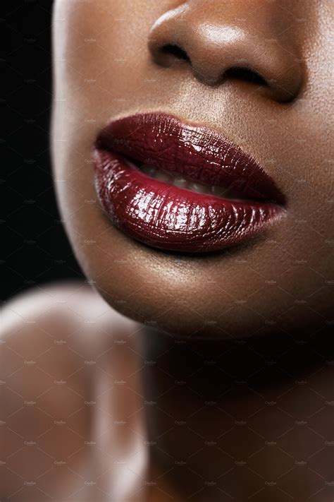 beautiful black woman red lips closeup featuring lip makeup and plump high quality beauty