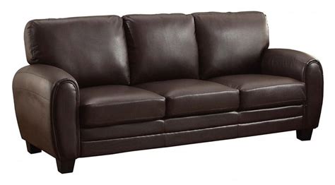 A Brown Leather Couch Sitting On Top Of A White Floor