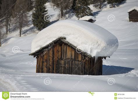 A Wood Cabin Hut In The Winter Snow Background Stock Photo