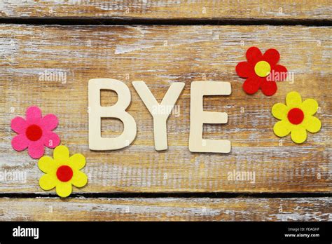 Word Bye Written With Wooden Letters On Rustic Surface And Colorful