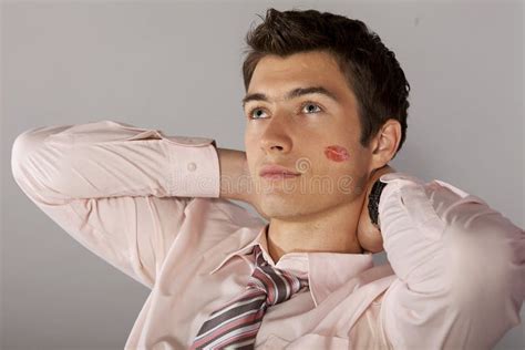 Young Caucasian Businessman With Lipstick Kiss Mark On His Cheek Stock
