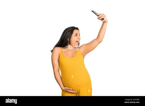 Portrait Of Young Pregnant Woman Taking A Selfie With Mobile Phone