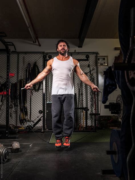 A Muscular Man Skipping Rope In A Gritty Gym By Stocksy Contributor