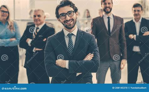 Confident Employee Standing In Front Of His Colleagues Stock Photo