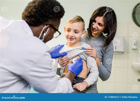Portrait Of A Little Boy Being Checked By A Doctor Using A Stethoscope