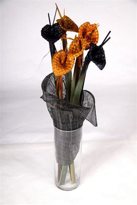 vase of yellow and black flax woven flowers creation of forever flax cesteria tejidos navidad