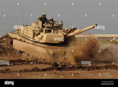 An Iraqi Army Tanker With The 9th Armored Division Drives An M1a1