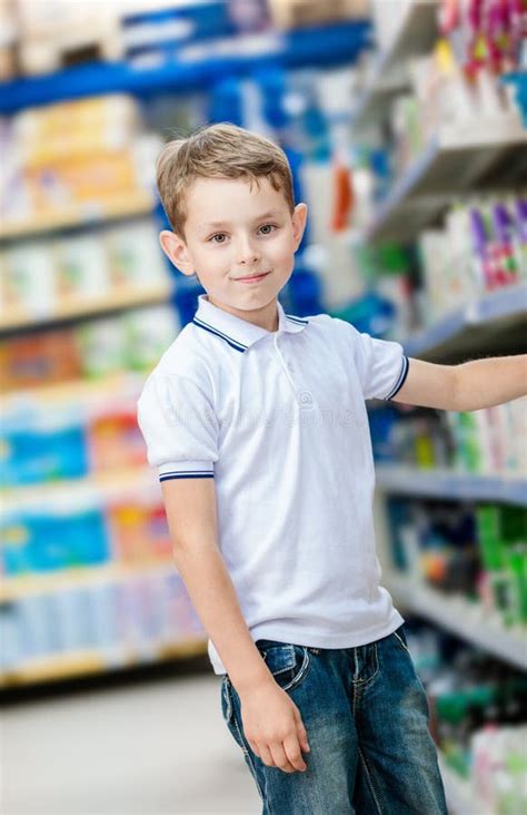 Little Boy Chooses Cosmetics In The Shop Stock Photo Image Of Color
