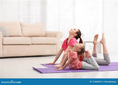 Young Mother With Little Daughter Practicing Yoga Stock Photo Image